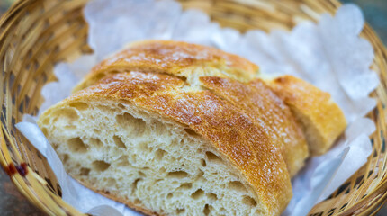 Close-up of whole fresh crispy tasty wheat bread in a basket
