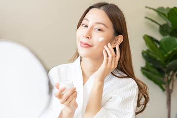 Facial beauty skin care, smile of pretty asian young woman in bathrobe looking at mirror, hand...