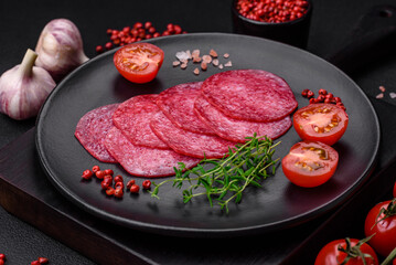 Delicious smoked salami sausage with salt, spices and herbs cut into slices