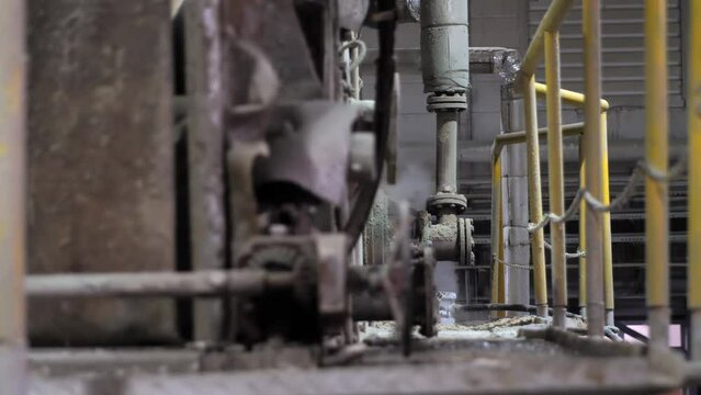 Steam coming from a huge machine for the production of paper from waste paper and pulp. Factory for the production of toilet paper, napkins and paper towels.