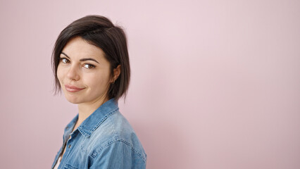 Fototapeta premium Young caucasian woman smiling confident over isolated pink background