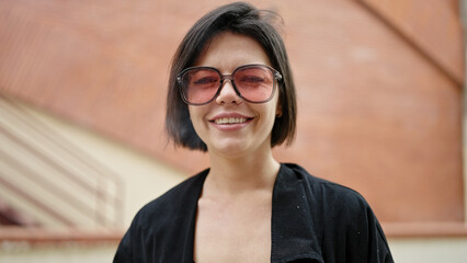 Young caucasian woman smiling confident standing at street