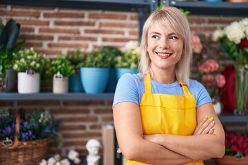 Young blonde woman florist smiling confident standing with arms crossed gesture at florist