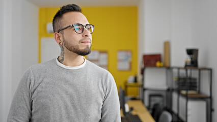 Hispanic man business worker with serious face looking to the side at office