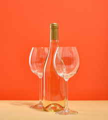 A bottle of delicious deluxe white sweet wine and two glasses are on the table. Romantic atmosphere.