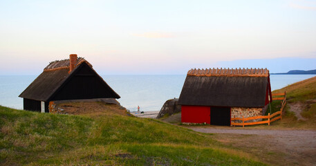 Red scandinavian wooden house with seascape in Haväng, Österlen, Sweden. Wooden cottage