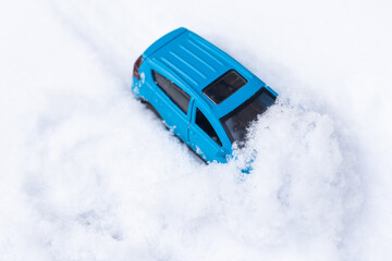 close up view of blue toy car with snow