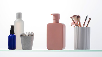 A set of cosmetics for the care and youth of the skin on a glass shelf. Layouts with a place for your logo.