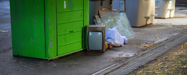 Garbage containers with bags, glass, crystals and an old telefunken crt tube television on the floor