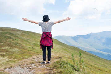 The girl feels freedom, a surge of new strength, great inspiration while resting in the mountains...