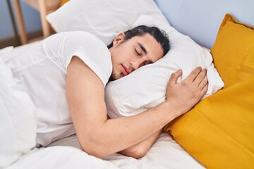 Young man sleeping on bed at bedroom