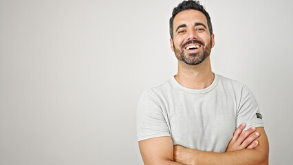 Young hispanic man smiling confident standing with arms crossed gesture over isolated white background