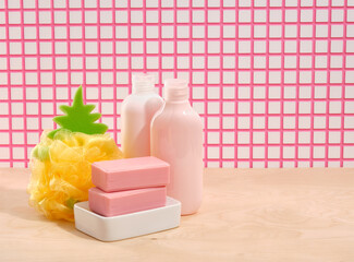 Shower gels for body cleanliness, pink soap, yellow sponge in the shape of a pineapple. Copy space for text.