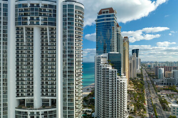Fototapeta na wymiar High angle view of Sunny Isles Beach city with expensive highrise hotels and condo buildings on Atlantic ocean shore. American tourism infrastructure in coastal southern Florida