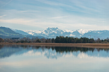 Lake Pfaeffikersee with the mountains in the background in Zurich in Switzerland