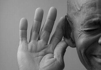 deaf man suffering from deafness and hearing loss on grey background with people stock photo