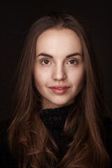 Closeup portrait of beautiful woman with brown hair posing at studio. cat's eyes style