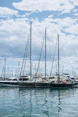 Fototapeta na wymiar Alicante, Spain - May 16, 2023: Summer Costa Blanca, Alicante - modern yachts, boats moored in the city marina. Trip concept. popular Spanish city. part of the city center