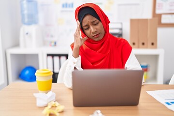 Young beautiful woman business worker stressed using laptop at office