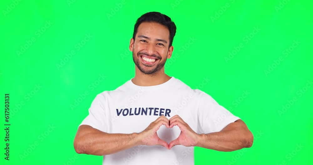 Poster heart, happy and man in a studio with green screen with a wink face expression fro flirting. happine