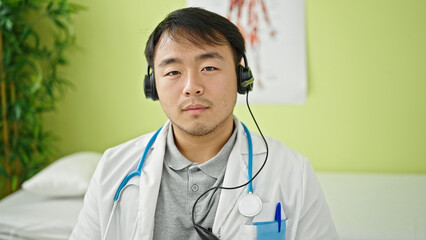  doctor wearing headphones with relaxed expression at clinic