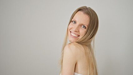 Fototapeta premium Young blonde woman smiling confident standing over isolated white background
