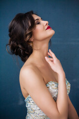 Fototapeta premium Beautiful woman in elegant evening dress. Professional make-up and hairstyle. Perfect skin. Fashion photo.