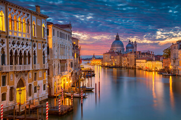 Fototapeta na wymiar Cityscape image of Grand Canal in Venice, with Santa Maria della Salute Basilica in the background.