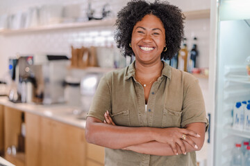 portrait of a coffee shop owner in Brazil with her arms crossed smiling at the camera