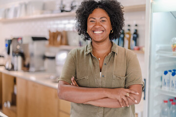 portrait of a coffee shop manager in Brazil with her arms crossed smiling at the camera