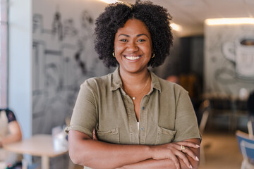 poportrait of a coffee shop owner in Latin America with her arms crossed smiling at the camera