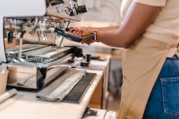 detail of the barista's hands making coffee on the espresso machine in a coffee shop in Brazil