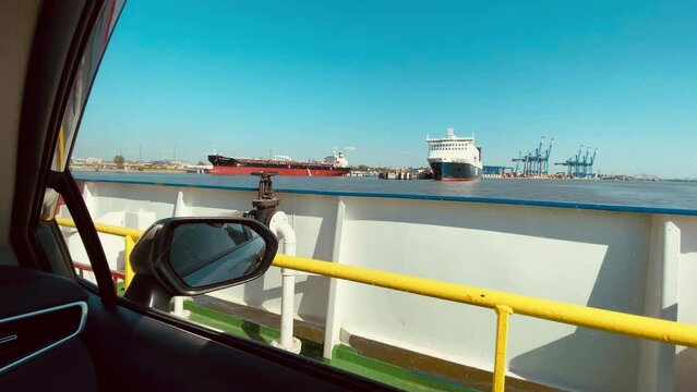 Klaipeda, Lithuania - 5th june, 2023 - tourist passenger driver pov sit in car on vehicle transfer ferry ship from curonian spit to Klaipeda port. Travel destination in Lithuania - Nida.