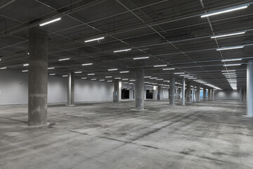 Abstract empty parking interior with concrete pillars and neon lights