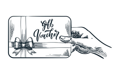Human hand holding gift voucher card. Discount coupon concept. Vector hand drawn sketch illustration - 617519387
