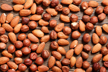 Almond and hazelnut  on a wooden table. Background with nuts.