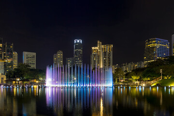 Fototapeta na wymiar Kuala Lumpur Malaysia City Skyline from KLCC Park by Symphony Lake water fountain light show at night