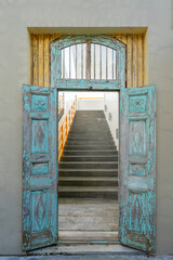 Old vintage open wooden door and steps in tropical island Koh Phangan, Thailand. Closeup