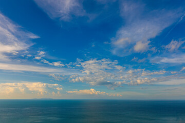 Fototapeta na wymiar Sunny day, blue sky, white clouds and sea water