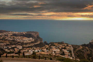 Panoramic view of Cumbre del Sol in Spain, villas on the hills and the sea at sunset, dramatic sky