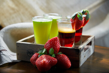 Tangerine Schnapps. Cocktail glass with high stem filled with orange liqueur splashing out on a black background, close-up, template design with sample text