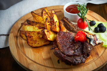 Grilled beef steak with baked potatoes and vegetables on plate