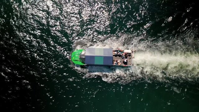 Top View of an Amphibious Tour Bus Floating in the Ocean off the Coast of Halifax Canada. Drone Shot Following an Amphibious Boat with Tourists Floating and Receding at the Waterfront. aerial view