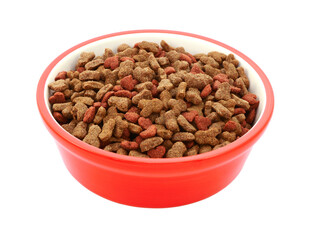 Dry cat biscuits in a red pet food bowl, isolated on a white background