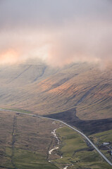 Beautiful sunset over the road in the valley in Streymoy, Faroe islands, Northern Europe, Scandinavia