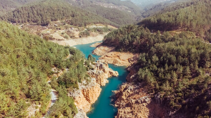 Fototapeta na wymiar Aerial view of a beautiful canyon and a river with turquoise fresh water. Nature travel background. Reservoir on the Dimchay River from a bird's eye view.