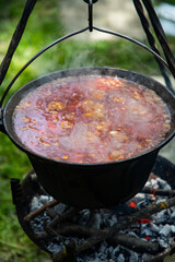 boiling chili con carne in a cauldron