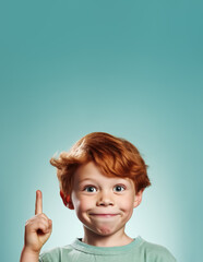 Small ginger red hair boy with freckles. He looks cute and innocent, but is probably naughty rascal. Smiles, pointing up finger  to empty copyspace. Vertical banner. Generative AI
