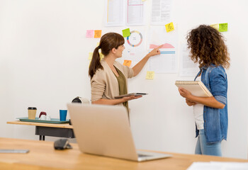 Shot of two businesswoman working together in an office