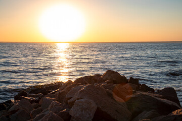 The sunset on the river, the rocky shore